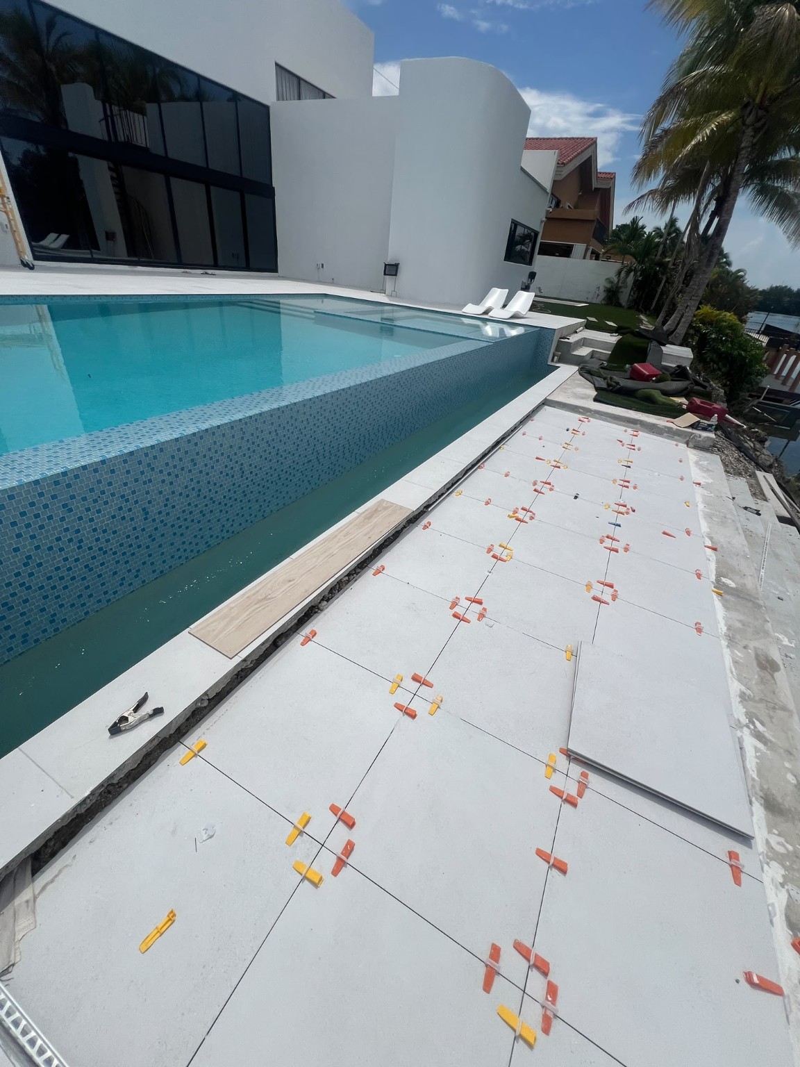 Exterior large-format tile installation in progress at a South Florida residence